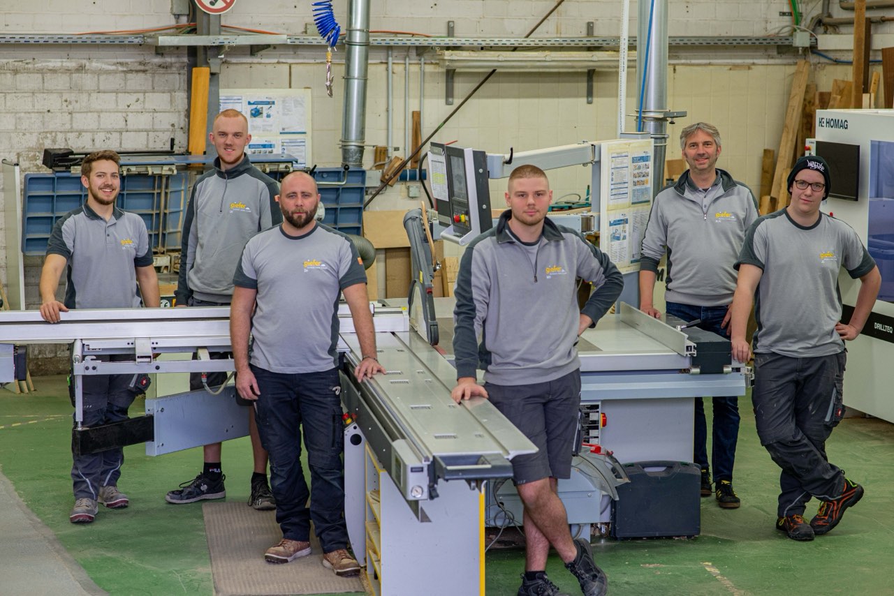 Das Team der Tischlerei Giefer in der Werkstatt an der Formatkreissäge